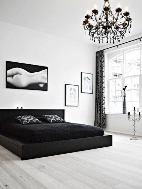 Modern Black and White Bedroom With Black Chandelier 