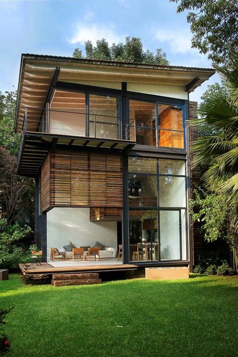 Modern home exterior with wooden features and large windows