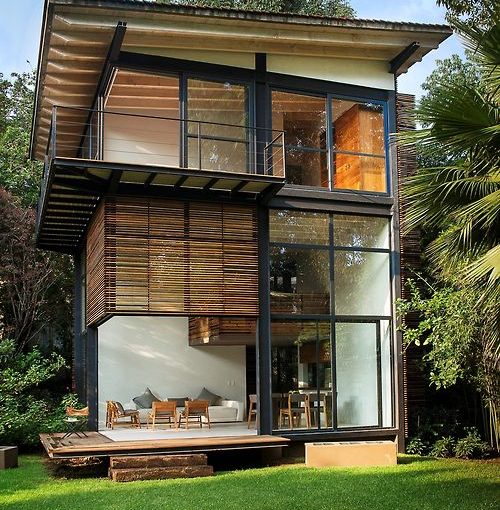 Modern home exterior with wooden features and large windows