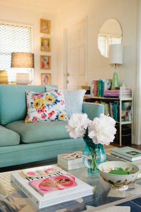 Green sofa with white flowers & floral cushion