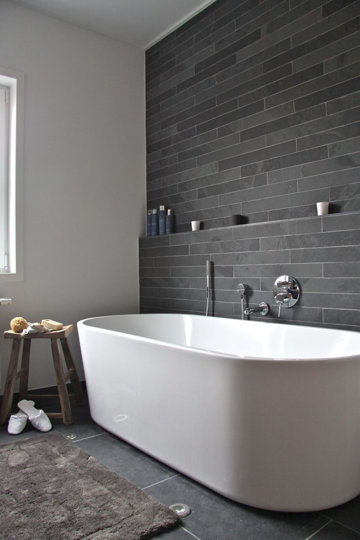 Transform Your Bathroom Into A Luxury Space In 5 Easy Steps - White Free Standing Bath, Grey Slated Walls & Wooden Stool.