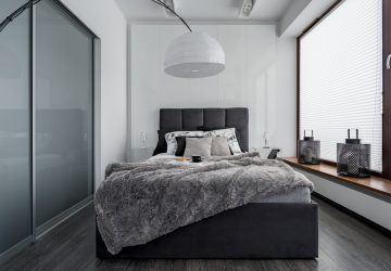 Gray and white bedroom with double bed, modern lamp and sliding door wardrobe