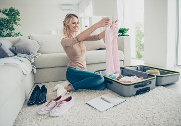 Women planing and packing suitcase for holiday