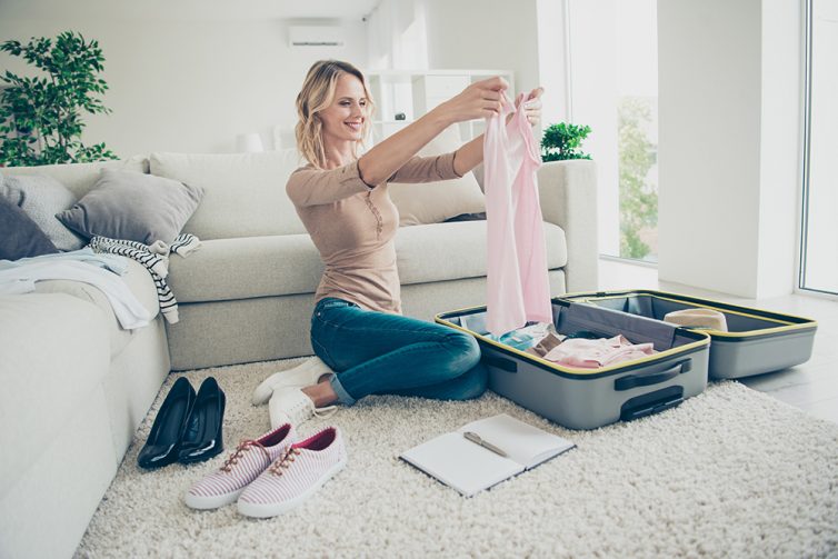 Women planing and packing suitcase for holiday