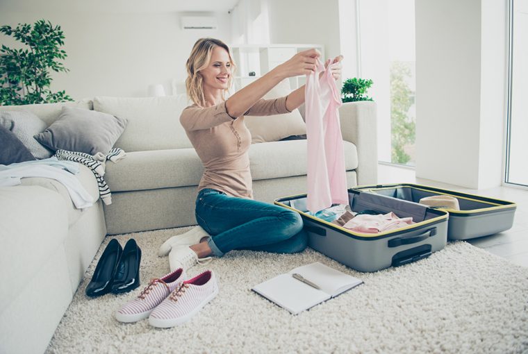 Women planing and packing suitcase for holiday