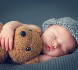 Baby With Grey Hat And Teddie Bear