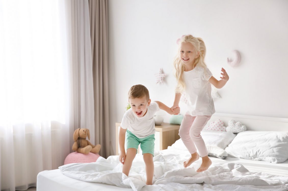 Children jumping on bed