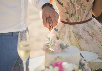 Wedding. Bride and groom cutting the cake