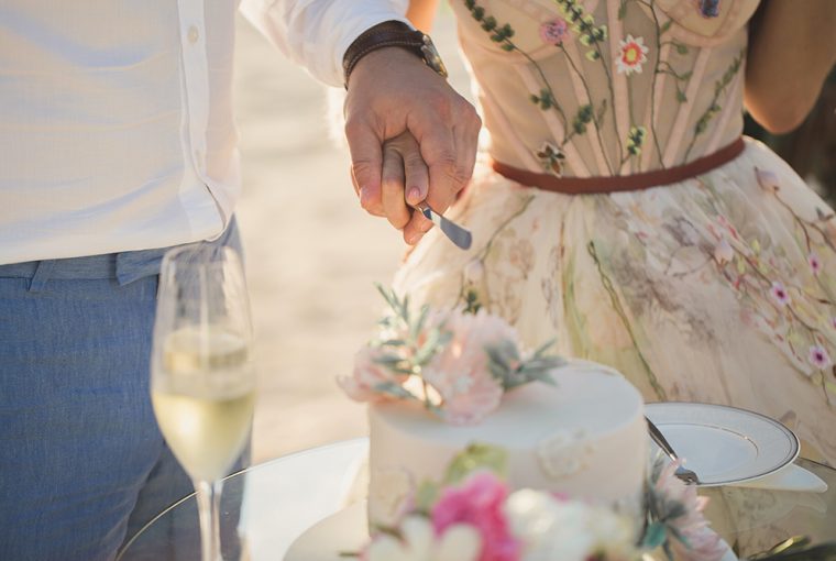 Wedding. Bride and groom cutting the cake