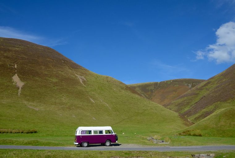 Purple VW camper van in the hills of Scotland