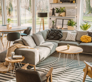 Nordic living room interior with large cosy grey corner sofa