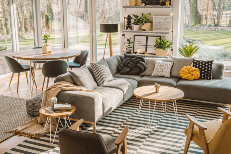 Nordic living room interior with large cosy grey corner sofa