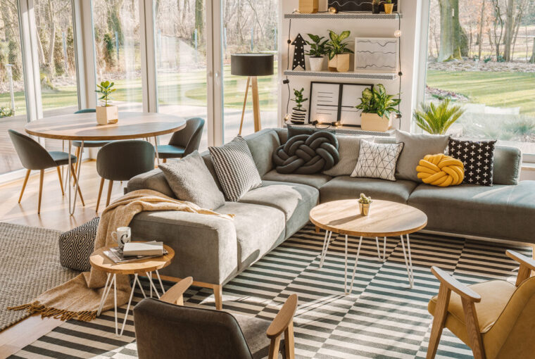 Nordic living room interior with large cosy grey corner sofa