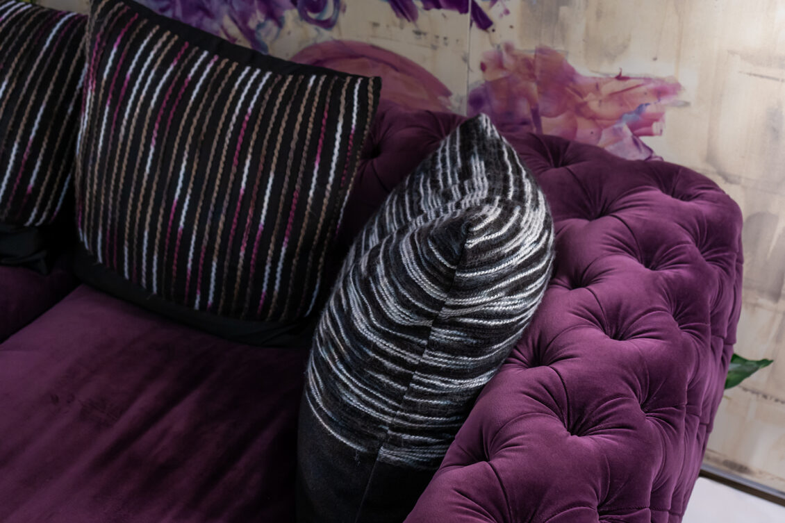 Puple velvet chesterfield sofa with striped cushions