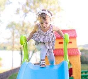 Young child playing on slide