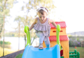 Young child playing on slide