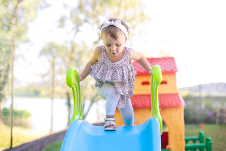 Young child playing on slide