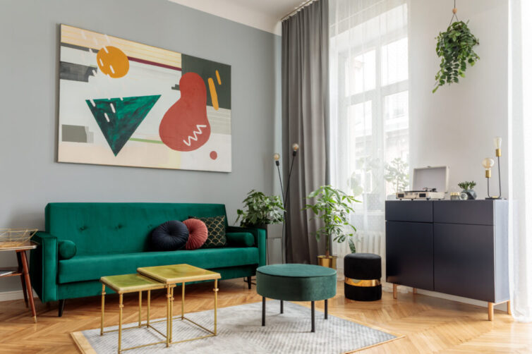 Living room with parquet flooring and green velvet sofa