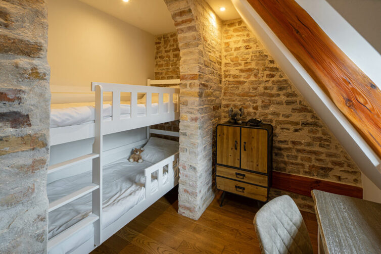 Bunk bed built in to loft wall space