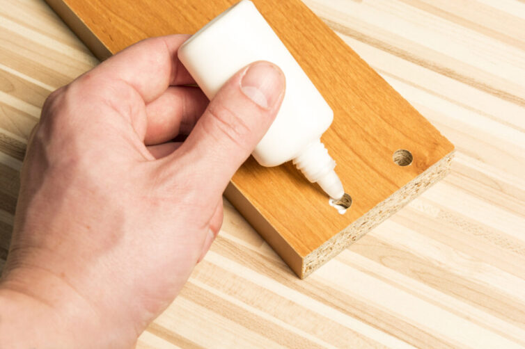 Applying glue to wooden board