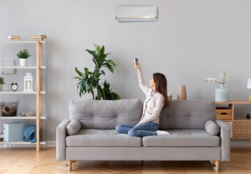 Women sitting on sofa using air conditioning