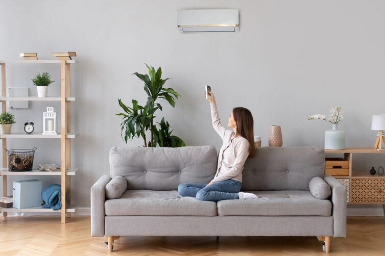 Women sitting on sofa using air conditioning