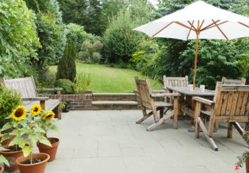 Garden with pathed patio and wooden patio furniture