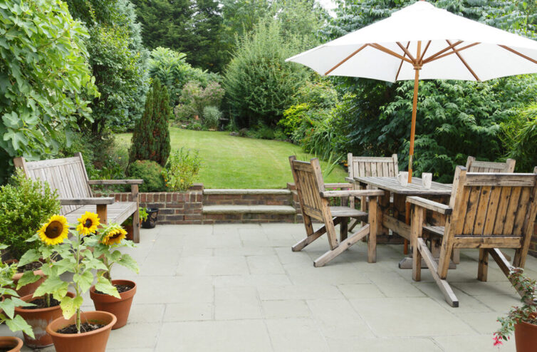 Garden with pathed patio and wooden patio furniture