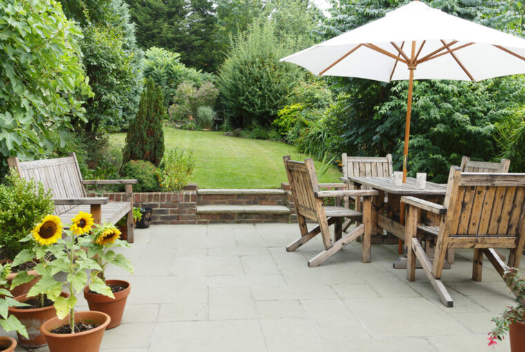 Garden with pathed patio and wooden patio furniture