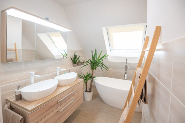 Bathroom with double sink, soft lighting and skylight