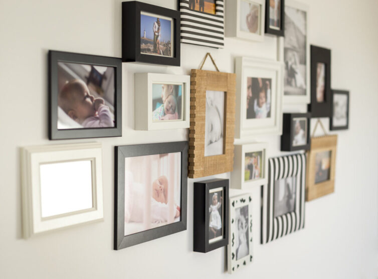 Family photographs in frames on the wall