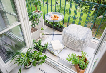 Balcony with cushion, plants and table