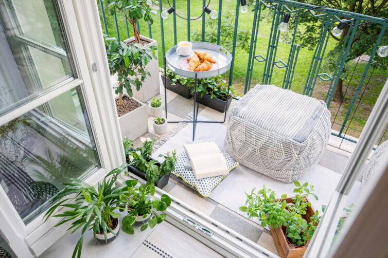 Balcony with cushion, plants and table