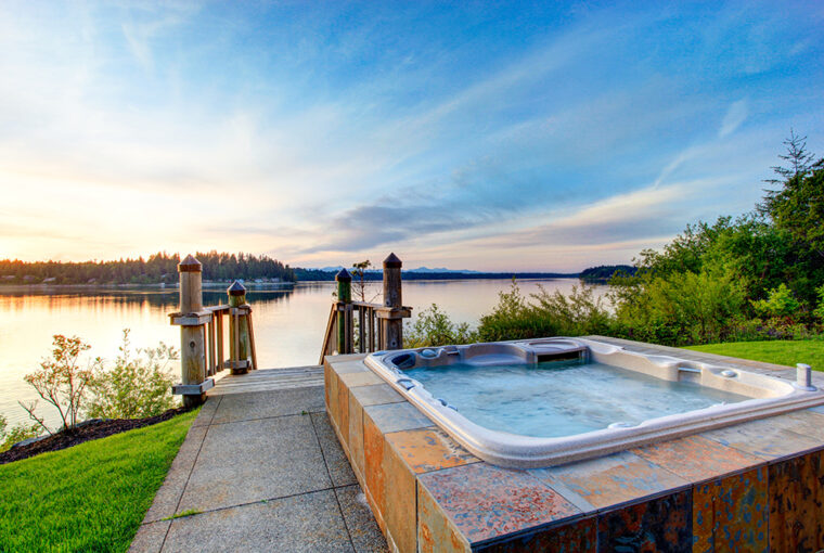 Hot tub in garden with sea views