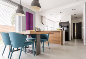 Purple radiator in contrast with white and wooden kitchen.