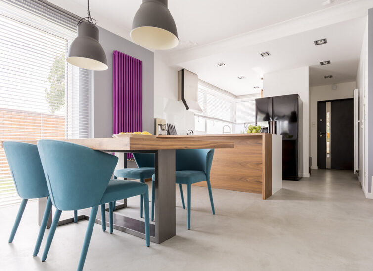 Purple radiator in contrast with white and wooden kitchen.