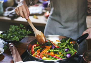 Woman cooking stir fried vegetables