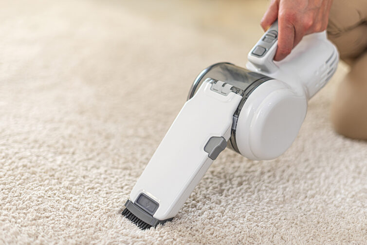 Portable Vacuum Cleaner being used on cream carpet