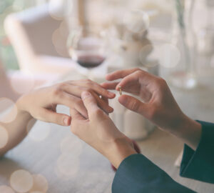 Man making marriage proposal to girlfriend at restaurant,