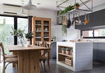 Eclectic Kitchen with real wood table and cupboard, ,metal hanging shelves and modern kitchen cabinets