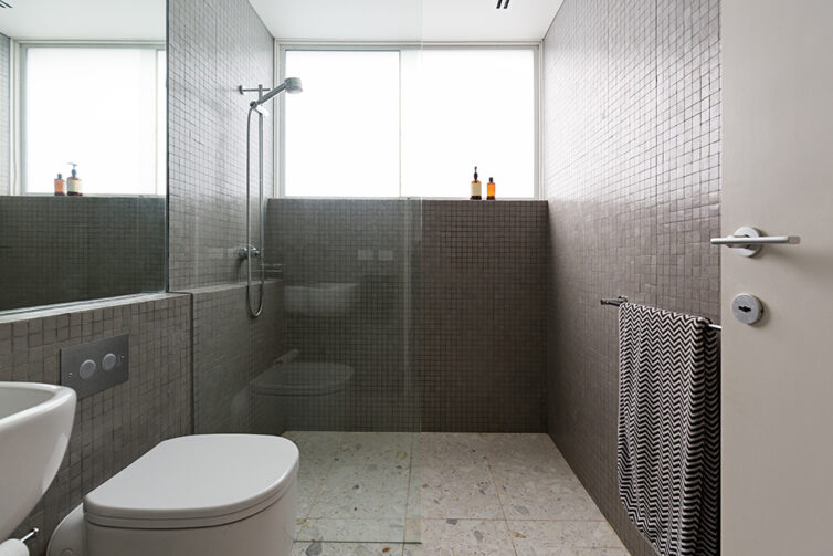 Modern walk in shower with mosaic tiles