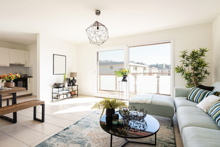 Modern appartment with glass slidding doors to balcony. Glass coffee table.