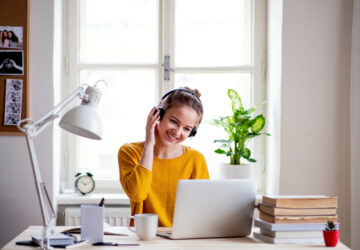 Women working and studying from home. Sat at desk with laptop.