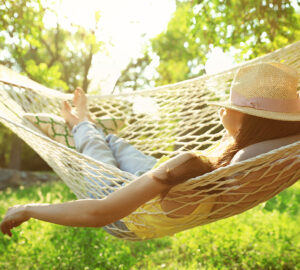 Women with hat. Relaxing in hammock