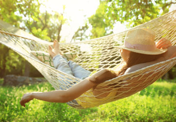 Women with hat. Relaxing in hammock