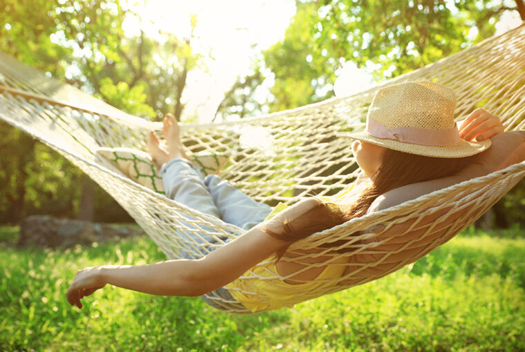 Women with hat. Relaxing in hammock