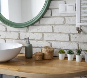 Bathroom sink and mirror. Decorated with plants.