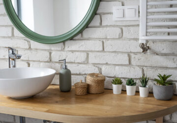 Bathroom sink and mirror. Decorated with plants.