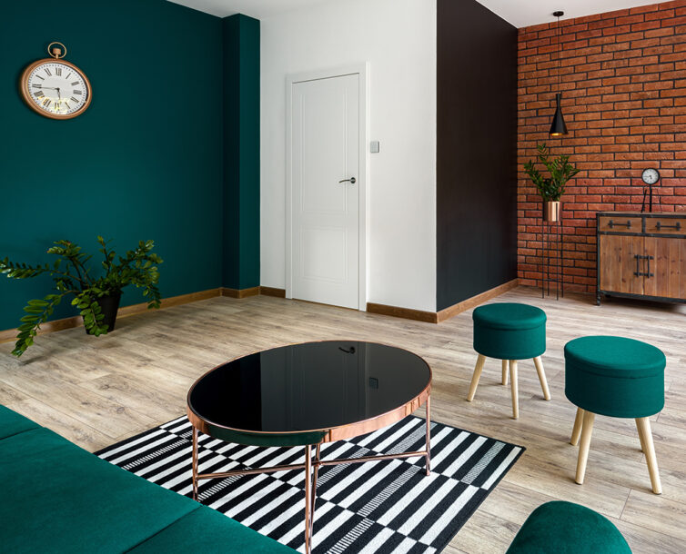 Stylish appartment with green sofa and dark glass coffee table