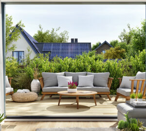 View of house with solar panels from garden patio.